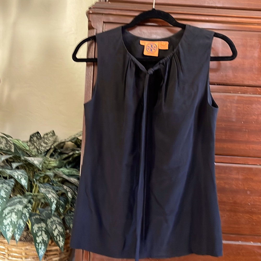 A sleeveless black top by Tory Burch